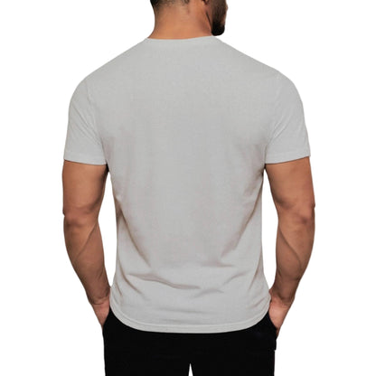 Man wearing a plain gray t-shirt on a light gray background